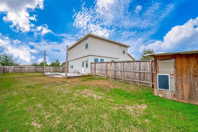 rear view of house featuring a patio area and a yard