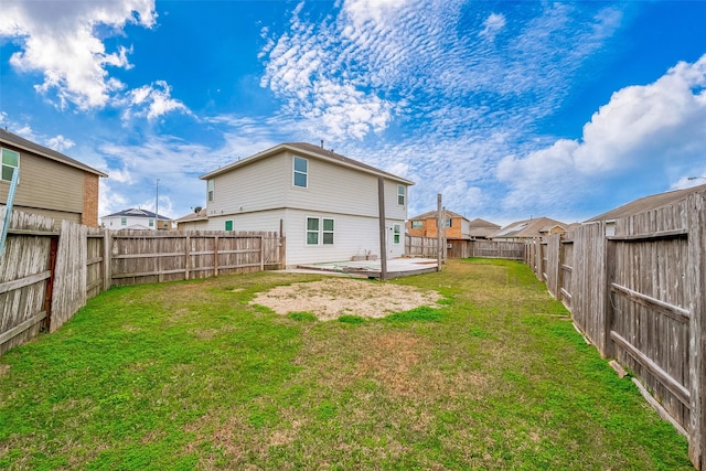 rear view of property featuring a lawn