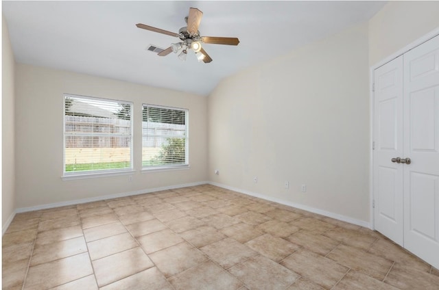 tiled spare room featuring ceiling fan and lofted ceiling