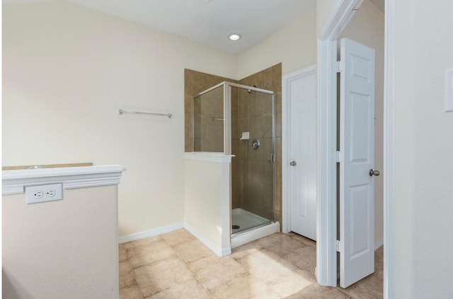 bathroom featuring tile patterned flooring and an enclosed shower