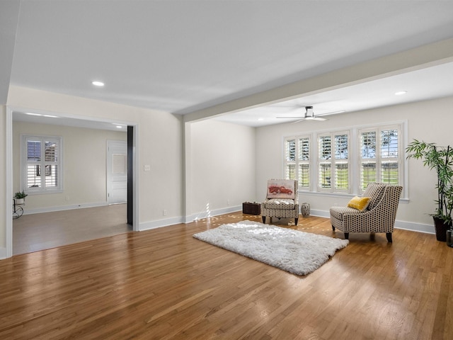 sitting room with hardwood / wood-style flooring and ceiling fan