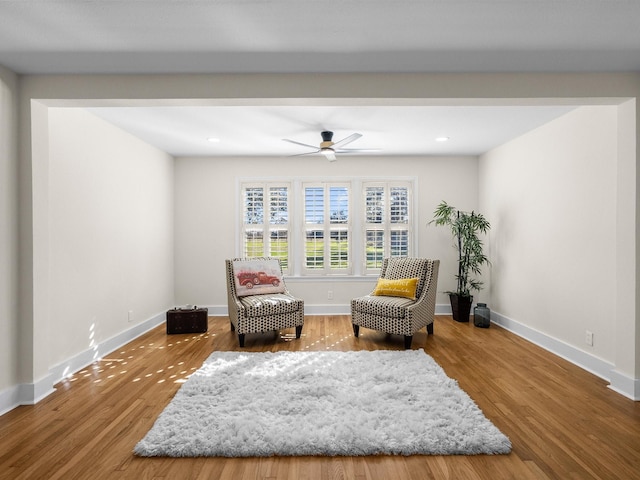 sitting room featuring ceiling fan and hardwood / wood-style floors