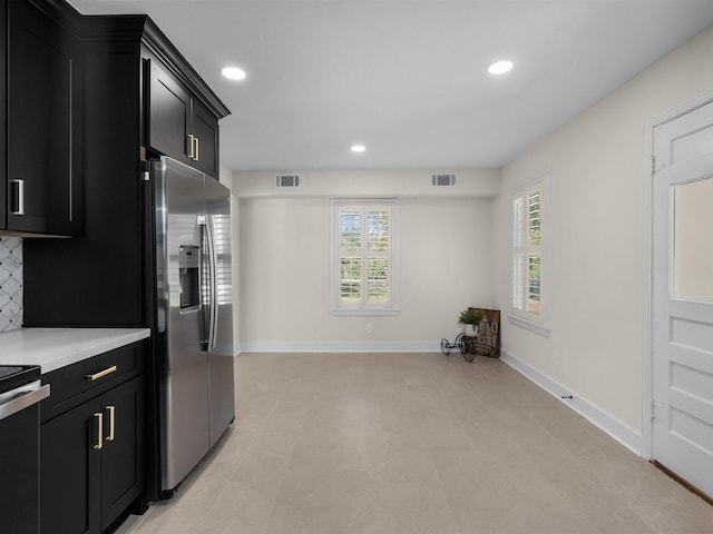 kitchen with decorative backsplash and stainless steel appliances