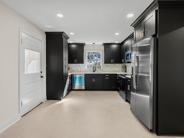 kitchen featuring backsplash, pendant lighting, sink, and stainless steel appliances