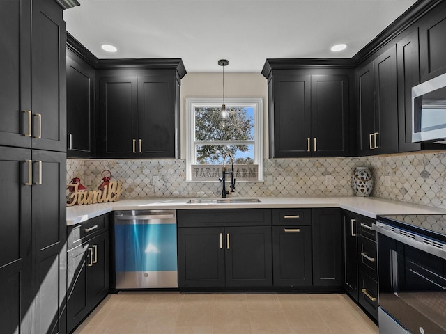 kitchen featuring backsplash, sink, pendant lighting, and appliances with stainless steel finishes