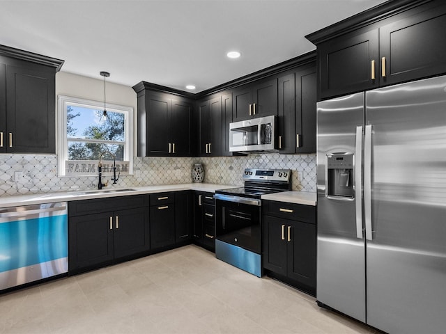 kitchen featuring backsplash, sink, stainless steel appliances, and decorative light fixtures