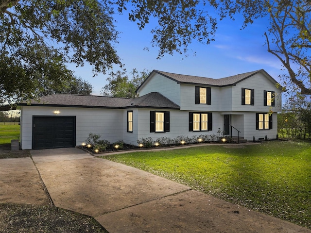 view of front of property with a lawn and a garage