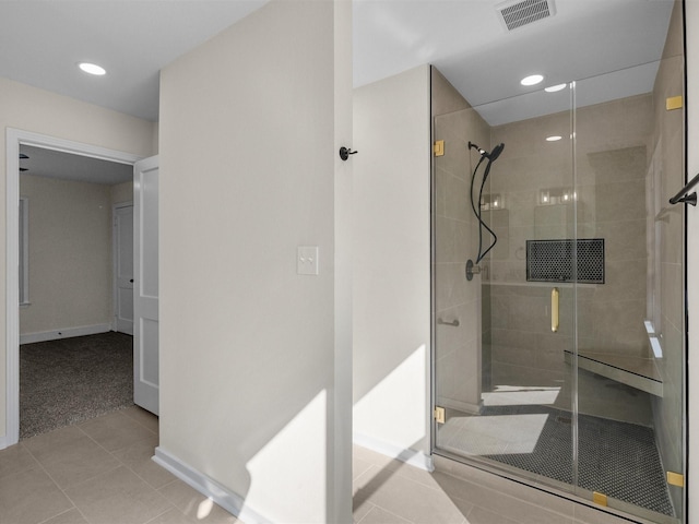 bathroom featuring tile patterned flooring and an enclosed shower