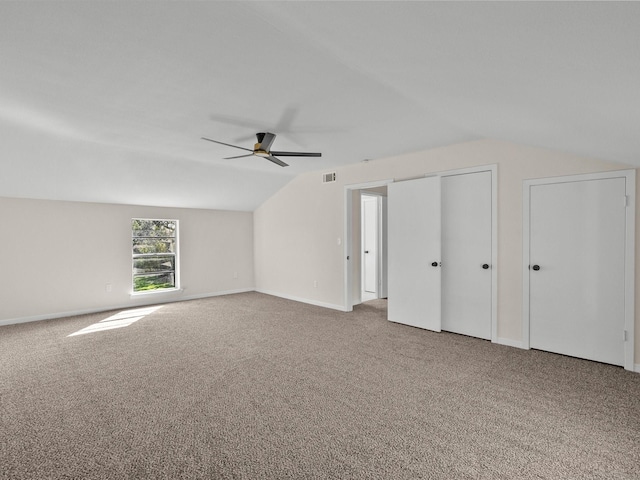 additional living space with carpet floors, ceiling fan, and lofted ceiling