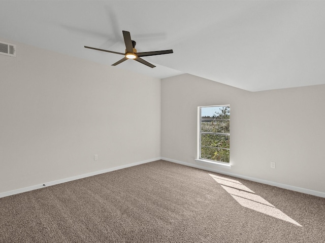 carpeted spare room with ceiling fan and lofted ceiling