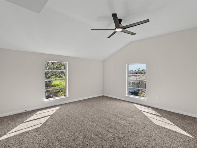 carpeted empty room featuring ceiling fan and vaulted ceiling