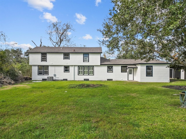 back of house with a lawn and central air condition unit