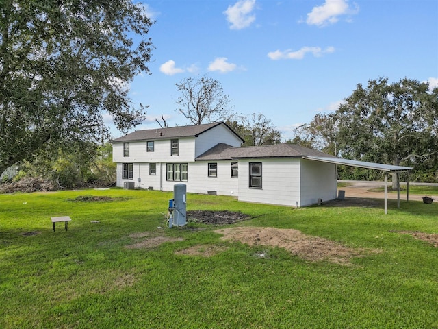 back of house with a yard and a carport