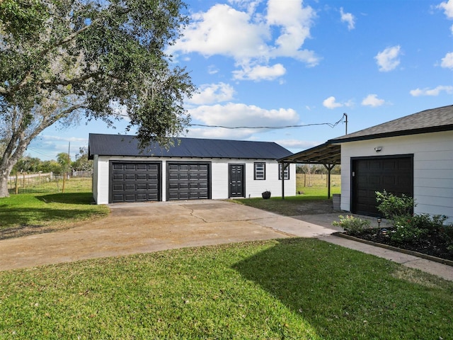 garage with a yard and a carport