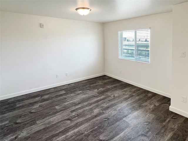 spare room with dark wood-type flooring