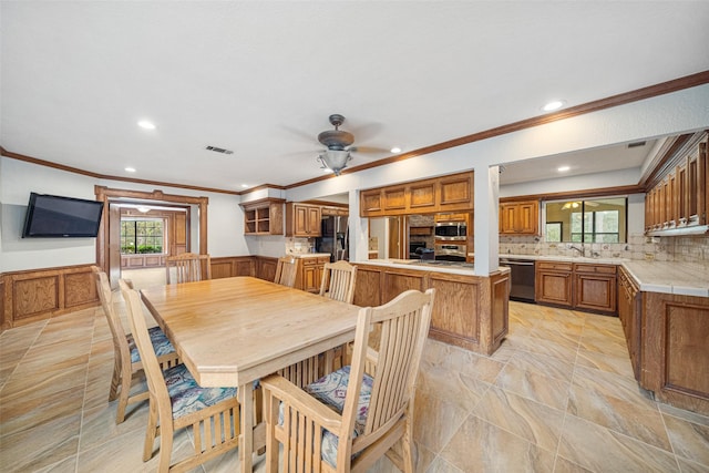 dining room featuring ceiling fan and ornamental molding