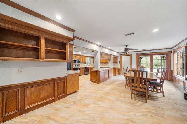 dining space with ceiling fan, crown molding, and french doors