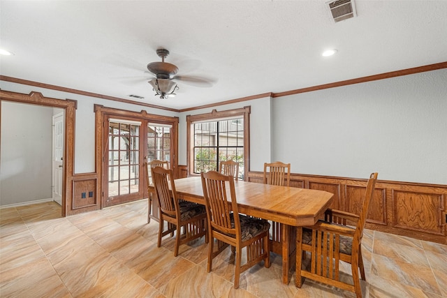 dining room featuring ceiling fan, crown molding, and french doors