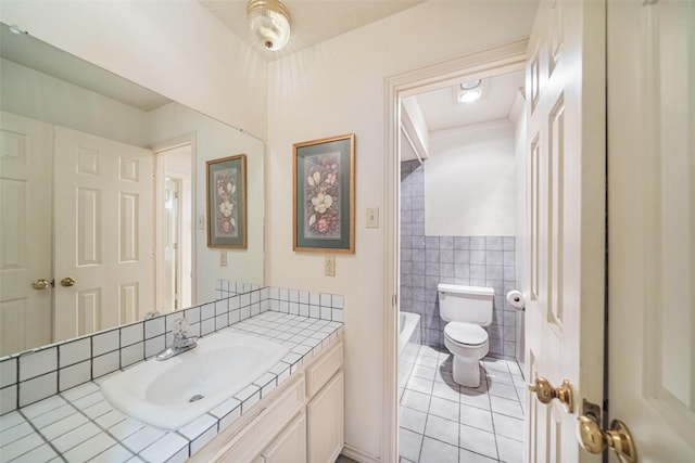 bathroom with tile patterned floors, vanity, tile walls, toilet, and a bathing tub