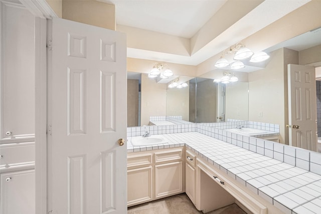 bathroom featuring vanity and a notable chandelier