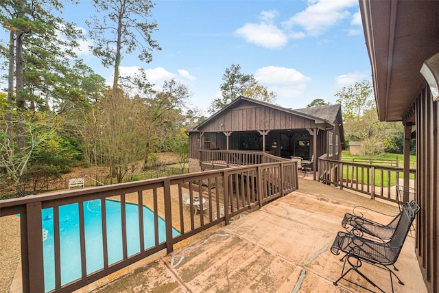 view of swimming pool with a patio area and a wooden deck