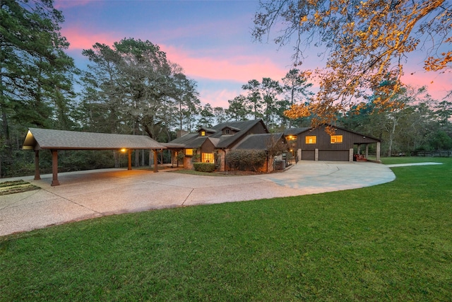 view of front of home with a lawn and a garage