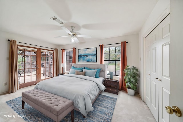 carpeted bedroom featuring french doors, a closet, access to outside, and ceiling fan