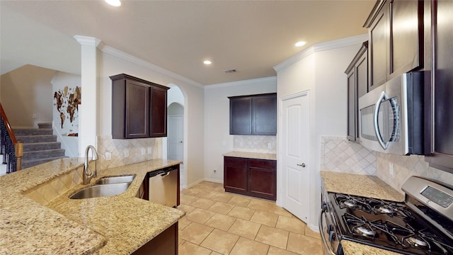 kitchen featuring appliances with stainless steel finishes, backsplash, light stone counters, ornamental molding, and sink