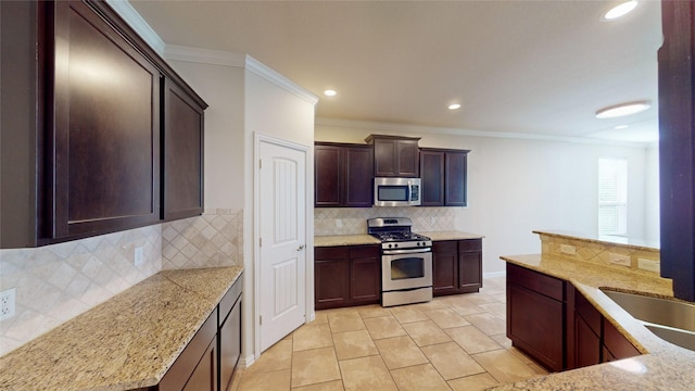 kitchen with light stone counters, ornamental molding, stainless steel appliances, and tasteful backsplash