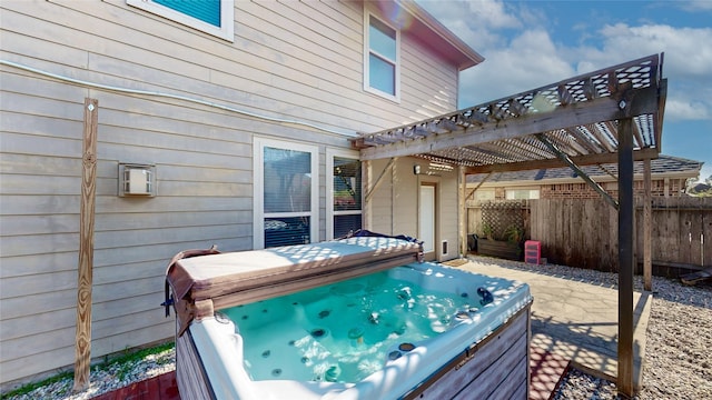 wooden deck with a pergola and a hot tub