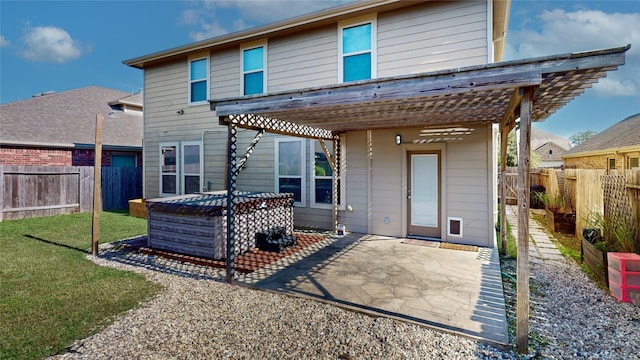 rear view of property with a patio and a hot tub