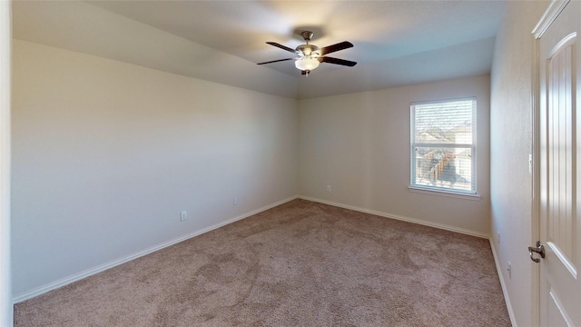 spare room with light colored carpet and ceiling fan