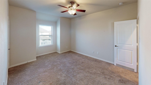 unfurnished room featuring light colored carpet and ceiling fan