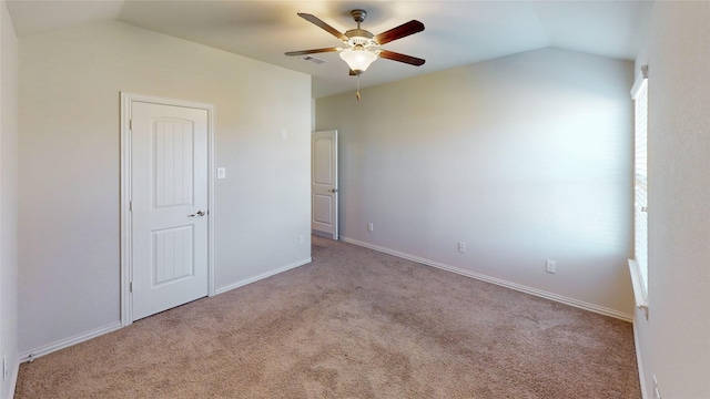 unfurnished bedroom featuring ceiling fan, light carpet, and lofted ceiling