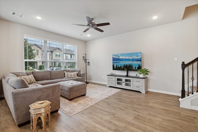 living room with ceiling fan and light wood-type flooring