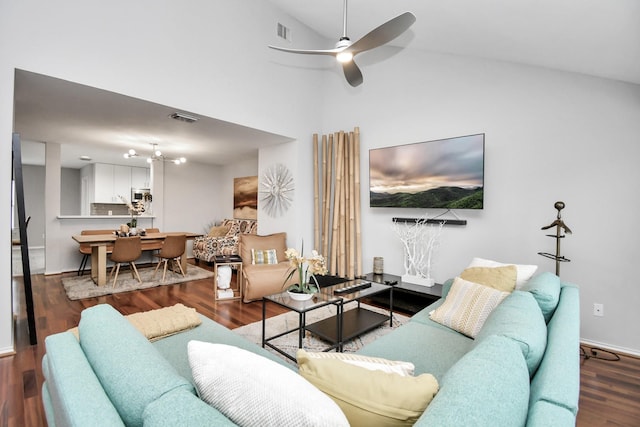 living room featuring ceiling fan, wood-type flooring, and vaulted ceiling