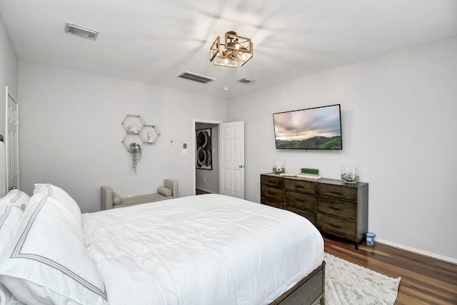 bedroom with dark hardwood / wood-style floors