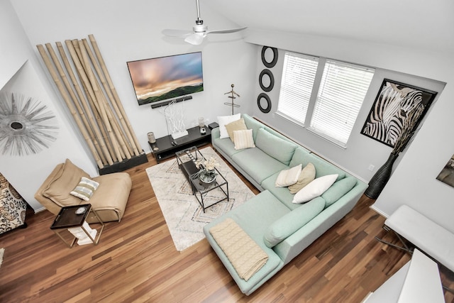 living room with hardwood / wood-style flooring, ceiling fan, and lofted ceiling