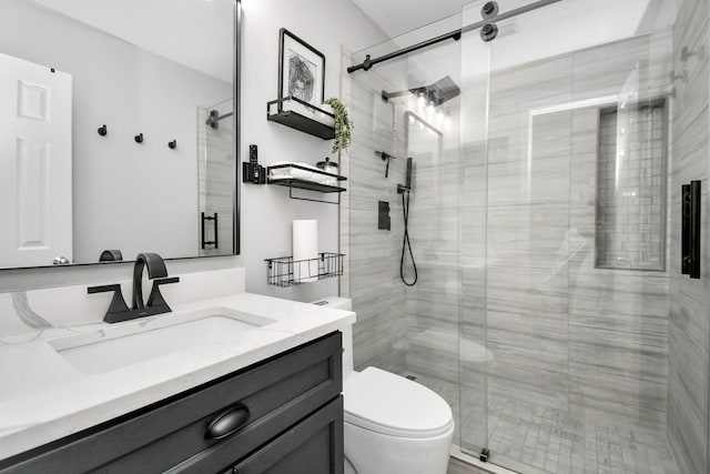 bathroom featuring walk in shower, vanity, and toilet