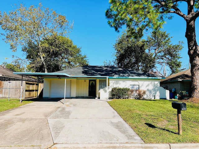 single story home featuring a carport, a garage, and a front lawn