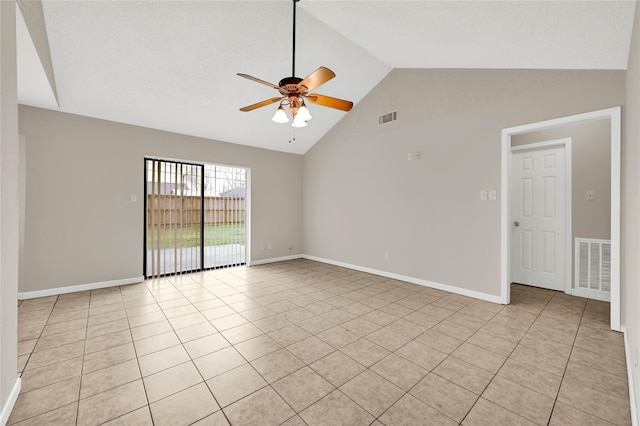 spare room with lofted ceiling, light tile patterned floors, and ceiling fan