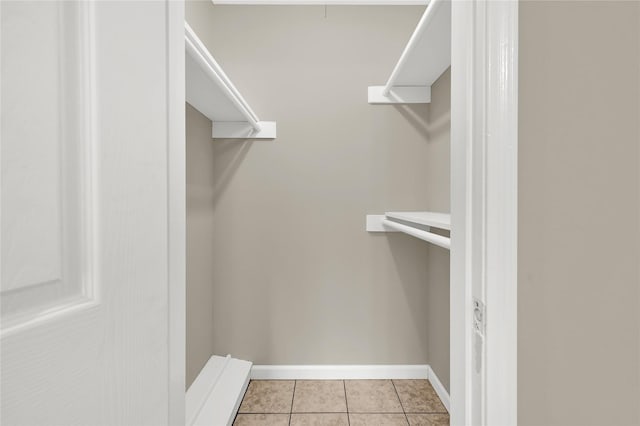 spacious closet with light tile patterned floors