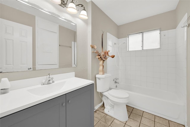 full bathroom with vanity, tiled shower / bath, tile patterned floors, and toilet