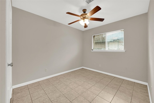 empty room with light tile patterned floors and ceiling fan