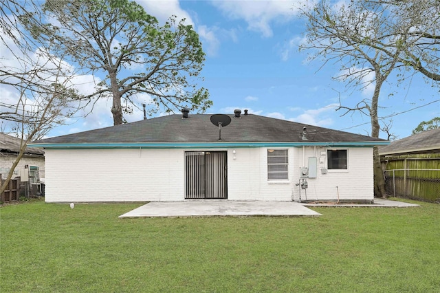 back of house featuring a patio and a yard