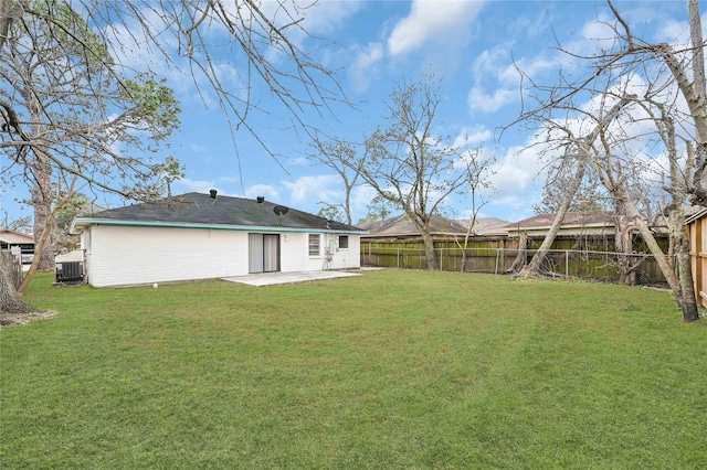 back of property with central AC, a lawn, and a patio