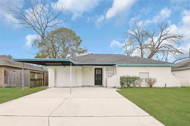 ranch-style home featuring a garage, a carport, and a front lawn