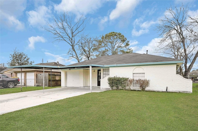 ranch-style home with a garage, a front yard, and a carport