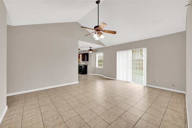 tiled empty room with vaulted ceiling and ceiling fan