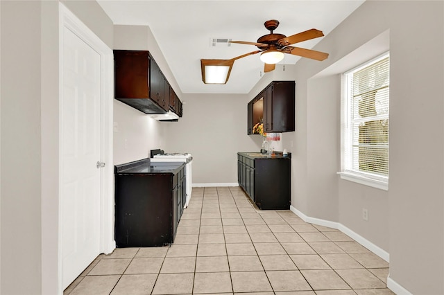 kitchen with ceiling fan, white range with gas cooktop, light tile patterned floors, and dark brown cabinetry